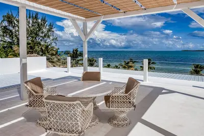 Luxurious beachfront home with private pool, rooftop grill, and sea views
