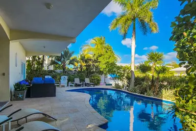 Waterfront home with private pool, bar/grill, screened patio, & boat access