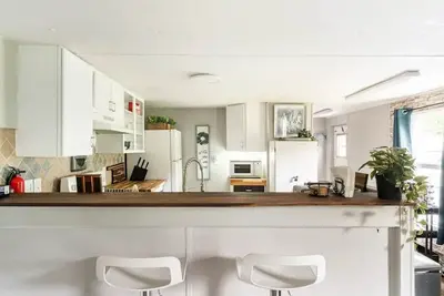Image de Cozy home with butcher block counter tops, custom live-edge walnut bar top