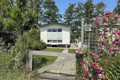 Image de A large chalet (for 6 people) in Beach style with a very beautiful view! There is a private garden, garden furniture with cushions, fully fenced, child friendly, barbecue.