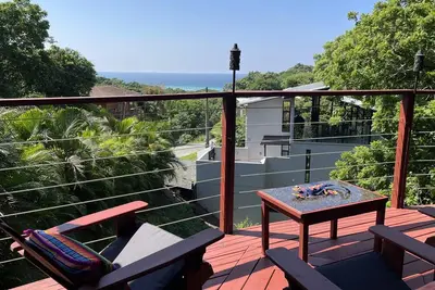 Image de Nestled on a lush hillside, offering comfort, sea views, and beach access.