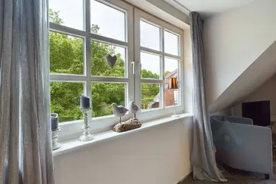 Image de Ferienwohnung Südstrandperle - Ferienwohnung Südstrandperle mit Großartigem Gartensitzplatz