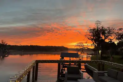 Image de River House w\/ 2-story dock, boat ramp, fire pits outdoor lounge area.