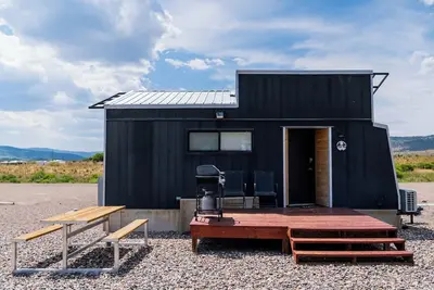 Image de This Tiny Home is custom made by a Colorado craftsman has one Queen bed in loft accessible by stairs and also has a fold out Full futon on main level. Sleeps up to 4. Please note, this home does have a sleeping area in a loft. If you require an accom