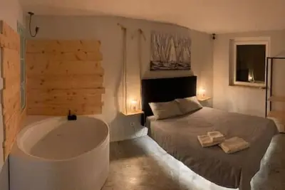 Image de Lake view apartment with large hydromassage tub directly in the bedroom.