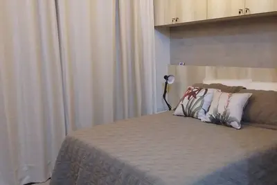 Image de Novo e moderno estúdio, com cozinha bem equipada e cama confortável.