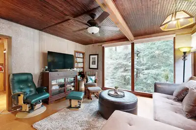 Image de Rustic chic retreat set back among the trees with furnished deck