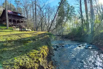 Image de Rustic creek-front cabin with private hot tub, game room, water views, & firepit