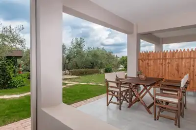 Nestled on the ground floor with direct garden access amidst olive trees