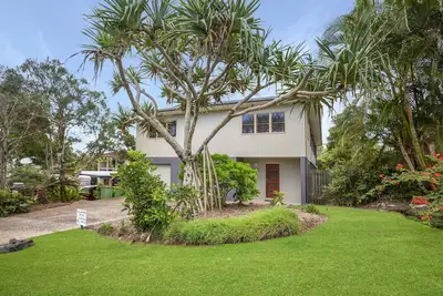 Image de Large family home with a wrap around deck catching the sea breeze.