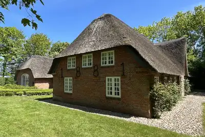 Image de Maison de vacances 'Deichglück Auszeit-Friesenhaus' avec terrasse privée, jardin privé et Wi-Fi
