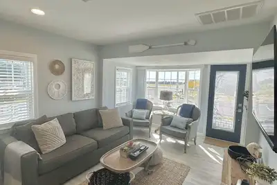 Relax here with beach views, steps to the beach, fenced in yard, pet friendly