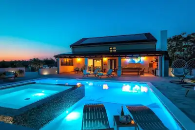 4 en-suite bedrooms, two finnish saunas, heated pool with Whirlpool, deck chairs in shallow area, natural surroundings