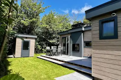Image de Beautiful, brand new and uniquely designed chalet with pretty garden. Very spacious, modernly furnished for 5 people with luxurious \"infinity\" gas fireplace, wash-and-dryer and free WiFi.