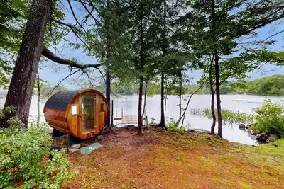 Image de Idyllic lakeside house with outdoor sauna, patio and firepit