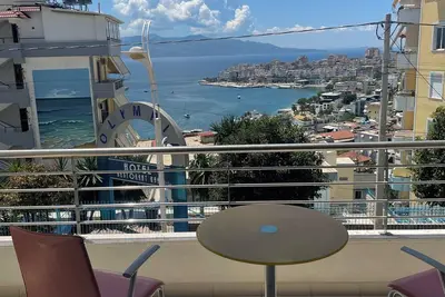 Image de The apartment has a beautiful view of the city and the sea with a balcony.