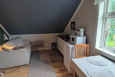 Image de Room with two single beds and a sofa bed.
