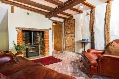 Charming medieval cottage courtyard garden and wood burner in serene Kersey