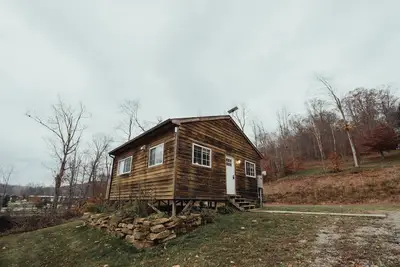 Image de The Hideout - Escape to The Hideout in Hocking Hills, Oh! This cozy, pet-friendly cabin offers a private deck by Pine Creek, just minutes from hiking, waterfalls, and caves. Perfect for up to 4 guests. Book your nature-filled getaway today!
