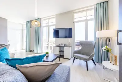Image de 5-star vacation apartment GroĂźe Welle with south-facing beach chair on the balcony