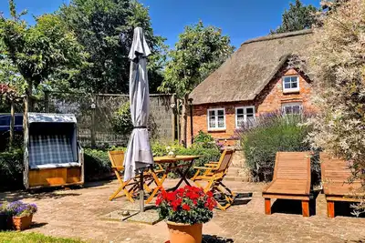 Image de Appartement 'Ferienwohnung Sannes' avec terrasse privée, jardin partagé et Wi-Fi