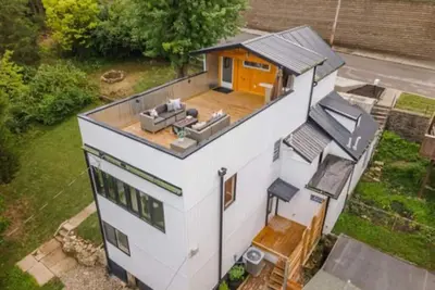 Downtown skyline vista featuring giant rooftop deck & wet bar with a city view