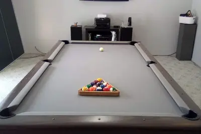Image de 8 ft Pool table on main floor game room with walk out patio door.