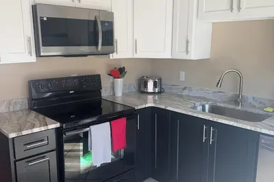Image de Large fenced in yard with updated kitchen