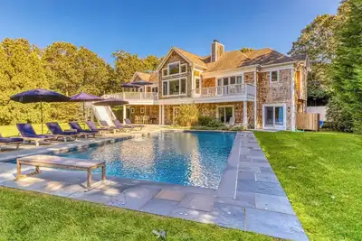 Image de Modern, coastal-style home with flooding natural light, a private pool, a. . .