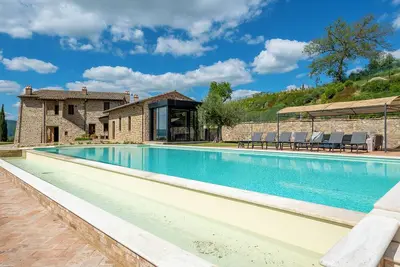 Image de Villa Lago is set against a hillside of luscious greenery olive groves