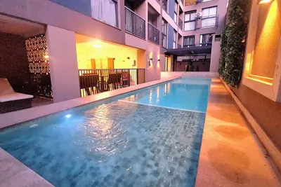 Image de Modern apartment with its own small backyard and swimming pool