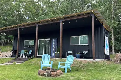 Image de Charming shipping container home with lake view and boat ramp.