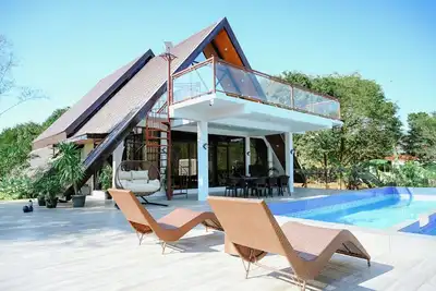 Step into an A-Frame home, where white tropical design meets ultimate comfort.