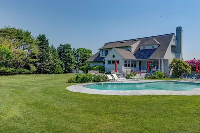 Image de Traditional-style home with private pool, sweeping back deck, grand lawn, . . .