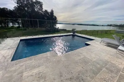 Sunset Lakefront with Private Pool – Your Dream Coastal Oasis!