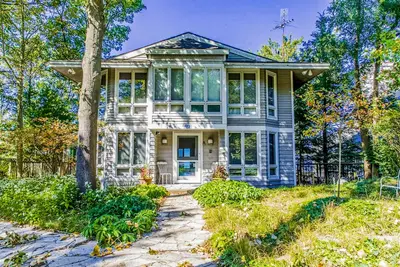 Image de Spacious lakefront home with private beach, hot tub, fire table, & views