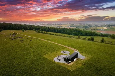 Image de we invite u to come experience this off grid tiny home on top of a grassy hilltop.