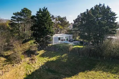 Image de This charming and spacious home offers ultimate comfort. It boasts a stunning panoramic view and a luxurious garden with a hot tub, perfect for relaxation.