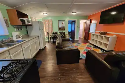 Image de Two Bedroom Cabin - Street & Pool View - Two bedroom cabin conveniently located at Outrigger Resort, right down the road from Indiana Beach Amusement Park! This 600 sq ft classic cabin offers two (2) queen beds and two (2) futons to sleep six (6)! Am