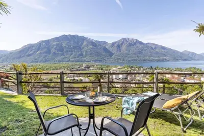 Vacation apartment with panoramic view and outdoor pool, garden seating area and sunbathing lawn