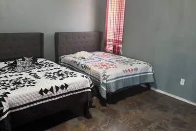 Image de Master bedroom with private restroom and private entrance. Two full beds+ futon