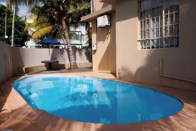Image de Homerez - Apt Ă Trou-aux-Biches avec piscine