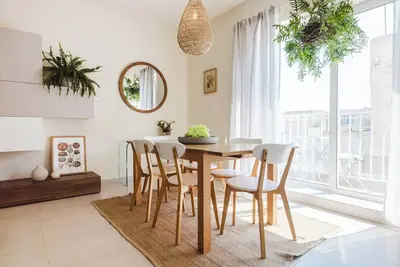 Image de Bright and stylish 2-bedroom apartment in the heart of Mellieha, Malta. Located in a quiet residential area, it features a charming louvered balcony, large sunlit windows, and modern interiors with natural touches—offering a peaceful and comfortable