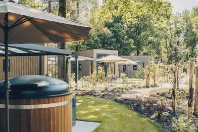 Image de Experience luxury and nature in the Reeëndal Lodge with hot tub in the Veluwe! With 1 bedroom and 1 sleeping loft, a fully equipped kitchen, and air conditioning.