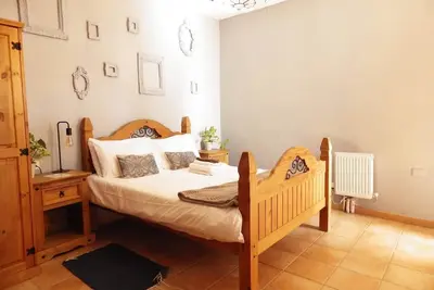 Image de This is a double room with a double bed. It has an en-suite bathroom. The window in the room looks out into the hallway.