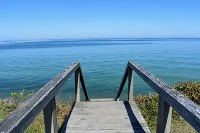 Rustic Oceanfront Retreat with Private Beach and Expansive Deck