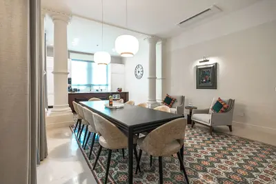 Image de An elegant retreat in Balluta Bay ✨ This designer apartment features refined textures, plush emerald seating, and timeless floor patterns — creating a luxurious sanctuary just steps from the sea 🌊🌿