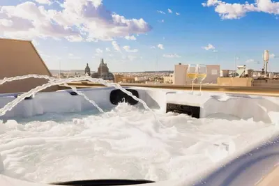 Image de Welcome to this brand-new penthouse in Tarxien, just steps from the famous Tarxien Temples. Enjoy a private jacuzzi on the spacious terrace, a stylish bedroom, and modern comforts—perfect for a romantic and relaxing Maltese getaway.