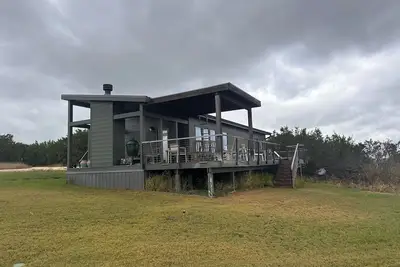 Image de luxury Cabin fireplace and covered deck. Located near Glen Rose Tx. Cabin 1 of 2