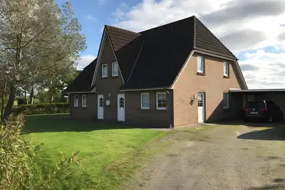 Image de Maison de vacances « Ferienhaus mit 4-Räume, 115 qm » avec terrasse privée, jardin commun et Wi-Fi